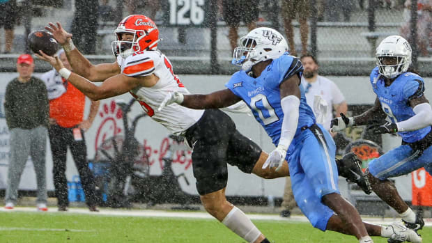 Nov 11, 2023; Orlando, Florida, USA; UCF Knights linebacker Jason Johnson (0) breaks up a pass against Oklahoma State Cowboys tight end Josiah Johnson (16) during the second quarter at FBC Mortgage Stadium. Mandatory Credit: Mike Watters-USA TODAY Sports
